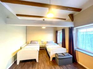 a hospital room with three beds and a window at Holiday Home in Konz in Konz