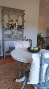a white table with a bowl of fruit on it at Stylish Studio in Reedy Creek in Gold Coast