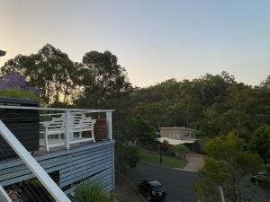 a balcony with a white chair on top of a house at Stylish Studio in Reedy Creek in Gold Coast