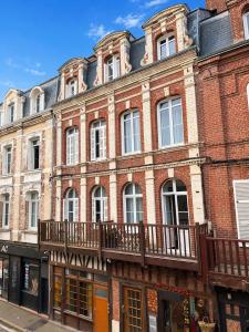 a large red brick building with a balcony at Résidence Gaïa - Etretat in Étretat