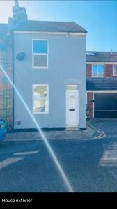 a blue building with a door in a parking lot at Medway Hidden Gem in Gillingham