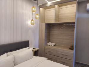 a bedroom with a bed and a closet with lights at Caye Caulker Condos in Caye Caulker