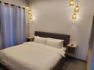 a bedroom with a bed with two night stands at Caye Caulker Condos in Caye Caulker