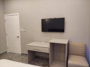 a room with a desk and a tv on the wall at Caye Caulker Condos in Caye Caulker +25 photos