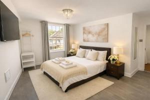 a bedroom with a large bed with two towels on it at Entire Apartment hosted by Pius in Redhill