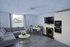 a living room with a couch and a table at Entire Apartment hosted by Pius in Redhill