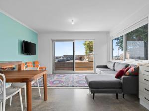 a living room with a couch and a table at Esplanade Escape in Indented Head