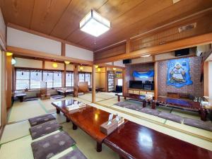 a large living room with a table and a tv at モンゴリアンテーマパークジャパン in Kamigō