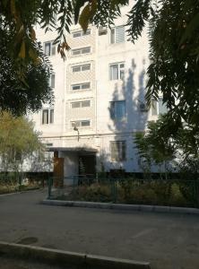 a large white building with a lot of windows at Мерей 1 in Qyzylorda