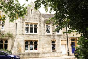 an old brick house with a car parked in front of it at 5 bed central home- beautiful modern in Witney