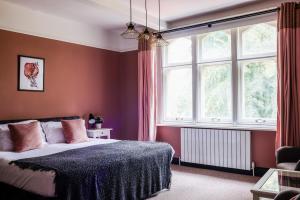 a bedroom with a bed and a large window at 5 bed central home- beautiful modern in Witney