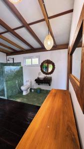 a bathroom with a toilet and a wooden table at La Bima Beach House in Sekongkang Bawa +45 photos