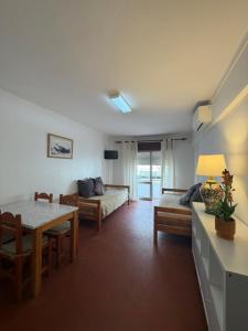 a living room with a couch and a table at PontesMar Apartamentos Central in Quarteira