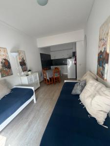 a small bedroom with two beds and a kitchen at PontesMar Apartamentos Central in Quarteira