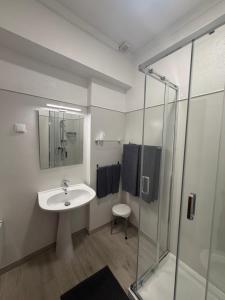a bathroom with a sink and a shower at PontesMar Apartamentos Central in Quarteira +22 photos
