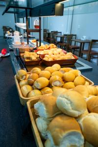 a buffet with bread and other foods on display at Barak Hotel in Nova Mutum