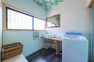 a small bathroom with a sink and a mirror at ようこそ月の宿へ in Shindembaru +59 photos