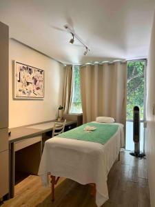 a bedroom with a bed and a desk and a window at Kubo Hotel & Business Center in San Miguel de Allende