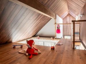 a room with a bed with a teddy bear sitting on the floor at Villa in Belgium with Private Terrace in La-Roche-en-Ardenne