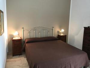 a bedroom with a bed with two night stands and two lamps at Terrazze sul Mare Melito Di Porto Salvo in Melito di Porto Salvo