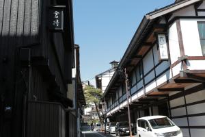 a white van parked in front of a building at 一棟宿 倉持 in Kusatsu