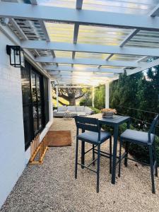 a patio with a table and chairs on a patio at Oakwood Guesthouse in Berrima