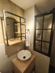 a bathroom with a sink and a mirror at MOCA Living in Cali +15 photos
