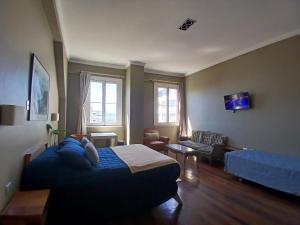 a living room with a bed and a couch at El Navegante B&B in Valparaíso +17 photos
