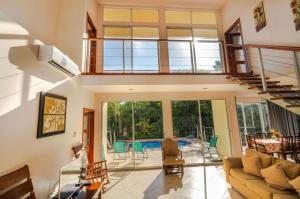 a large living room with a couch and a table at Casa de Fox - Confort en medio de la jungla! in Manuel Antonio