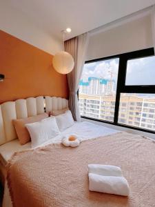 a bedroom with a bed with a stuffed animal on it at Honey Vinhomes in Long Bình +35 photos