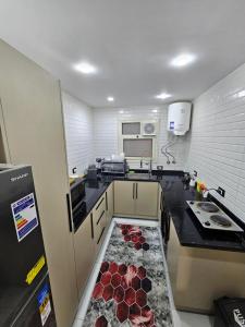 a kitchen with a counter with a floor in the middle at Salalah Apartment in Cairo +10 photos