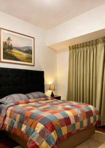 a bedroom with a bed with a colorful blanket at Hospedaje Paris in Cusco