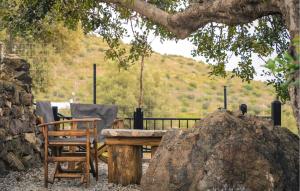 a wooden table and chairs under a tree at Prinos 3 in Agia Galini +9 photos