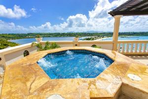 a swimming pool on top of a house at Villa Nirvana in North Hill Village