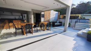 a patio with a table and chairs on a deck at Mahalo Flat Cabo Branco Genius Flats in João Pessoa +16 photos