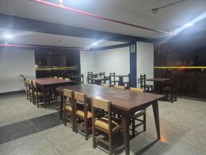 a dining room with wooden tables and chairs at Hotel Naciones Unidas in Lima