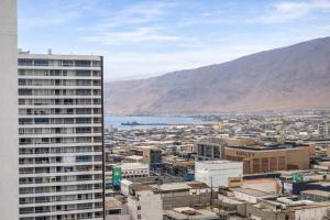 a view of a city with a tall building at Edificio iquique obispo labbe 830 in Iquique +3 photos