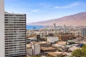 a view of a city with a tall building at Edificio iquique obispo labbe 830 in Iquique