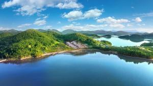 an island in the middle of a river with trees at Yeosu The Shine Blue Pool Villa in Yeosu