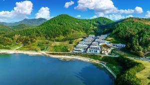 an aerial view of a resort near a body of water at Yeosu The Shine Blue Pool Villa in Yeosu