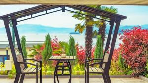 a table and two chairs with a pergola at Yeosu The Shine Blue Pool Villa in Yeosu