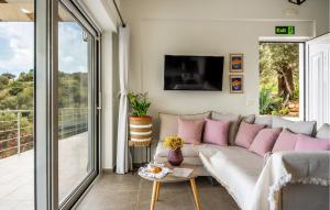 a living room with a couch with pink pillows at Thyme 1 in Agia Galini