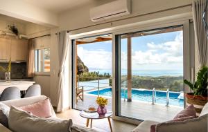 a living room with a large sliding glass door at Thyme 1 in Agia Galini