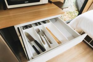 a drawer in a table with utensils in it at Pinelight Retreat in Kuei-chu-lin