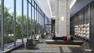 a lobby of a building with a bench and chairs at Village Atami in Atami