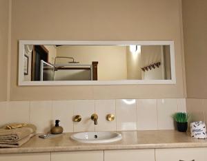 a bathroom counter with a sink and a mirror at 12 apostles cottages in Princetown