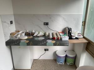 a room with a counter with dishes and other items at Rifugio Urbano in Terni