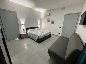 a bedroom with a bed and a couch in it at Rifugio Urbano in Terni