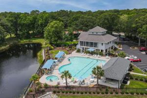 an aerial view of a pool at a resort at 2BR Condo with Golf Views Near Sunset Beach in Sunset Beach