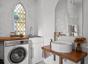 a kitchen with a washing machine and a sink at The Church Millers Flat in Millers Flat